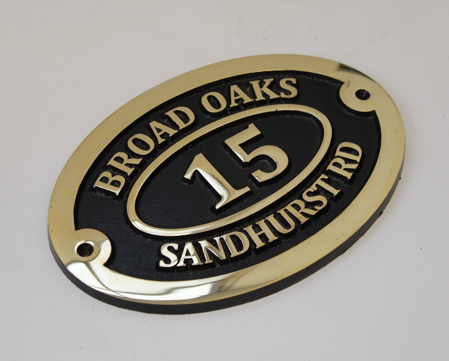 Bronze address sign black background