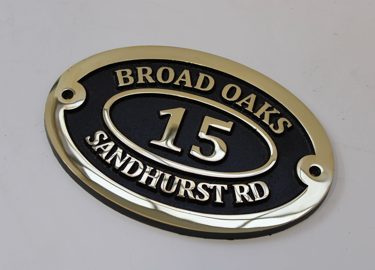 Bronze address sign black background
