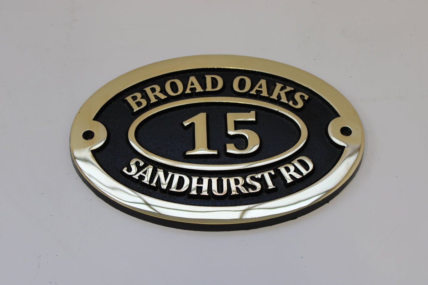 Bronze address sign black background
