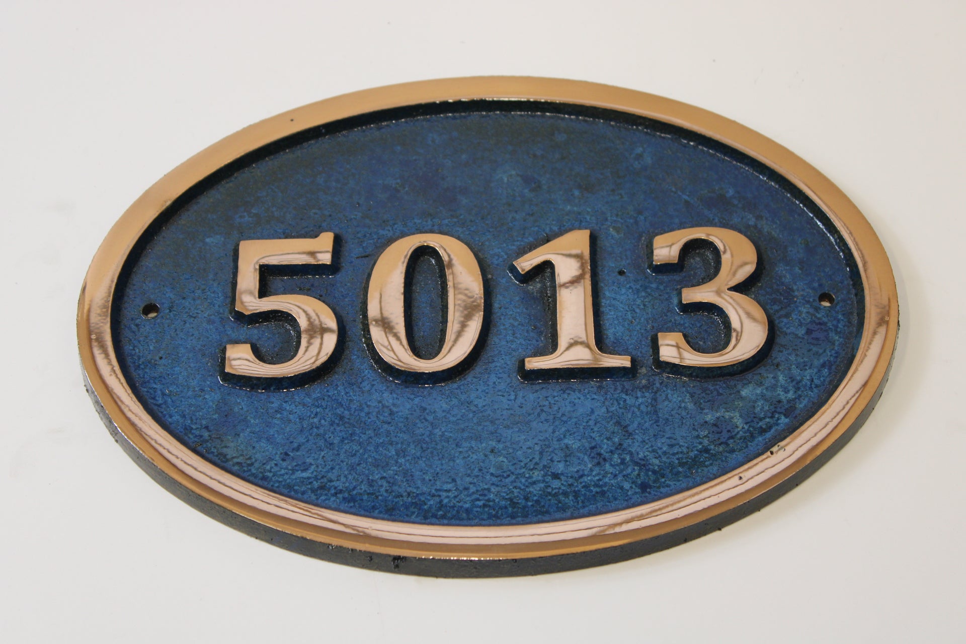 House number sign in Cast Copper blue background