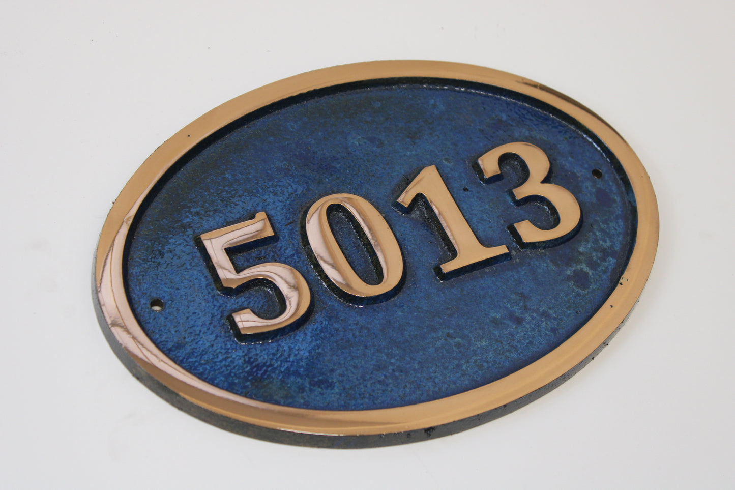 House number sign in Cast Copper blue background