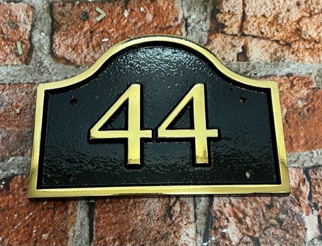 brass house sign with number