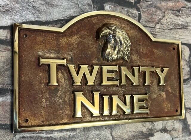 House plaque with curved top red patina