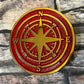 bronze compass in red