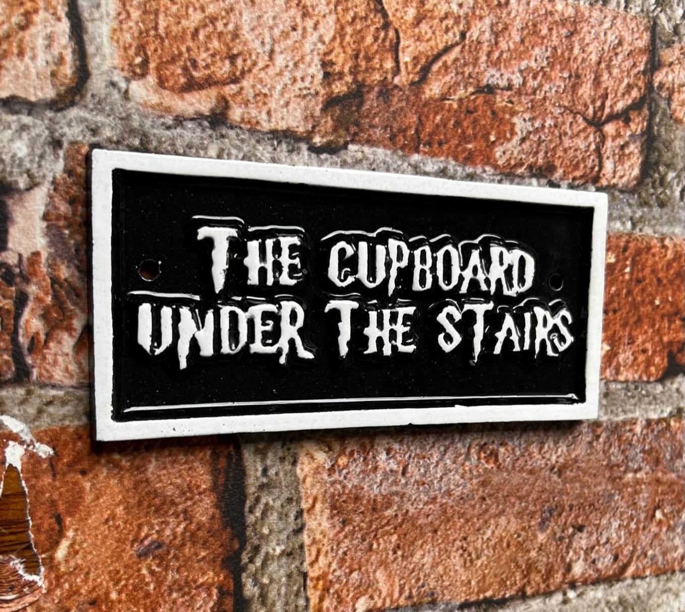 the cupboard under the stairs sign