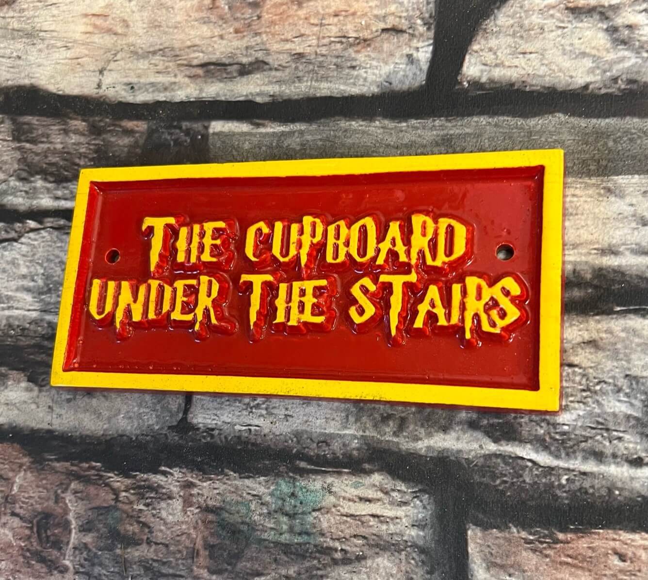 the cupboard under the stairs sign