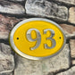 house number sign oval in yellow