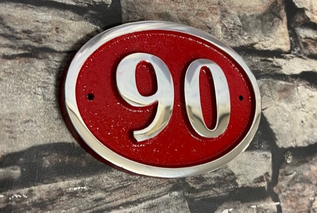 House number sign in aluminium red background