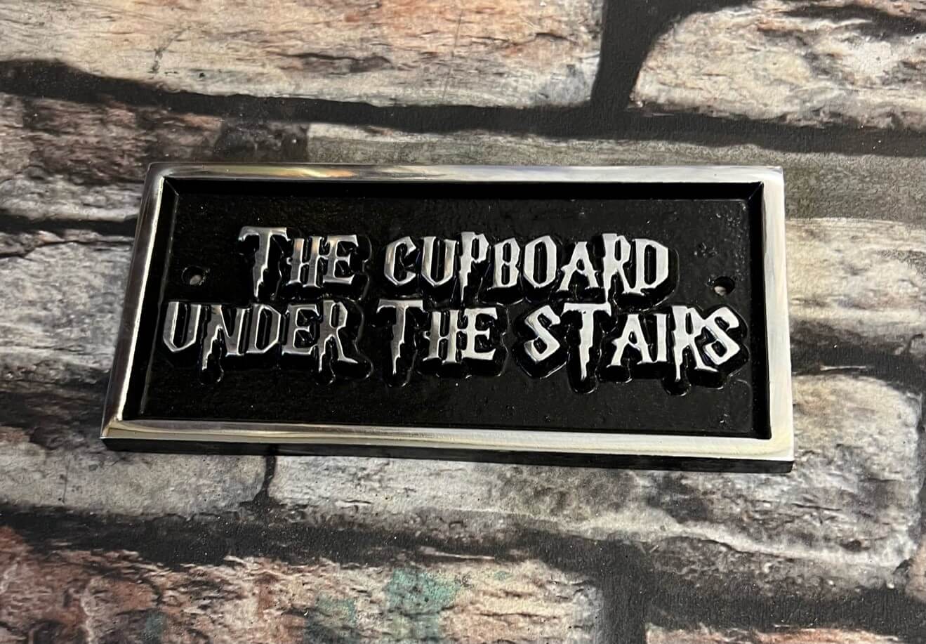 the cupboard under the stairs sign