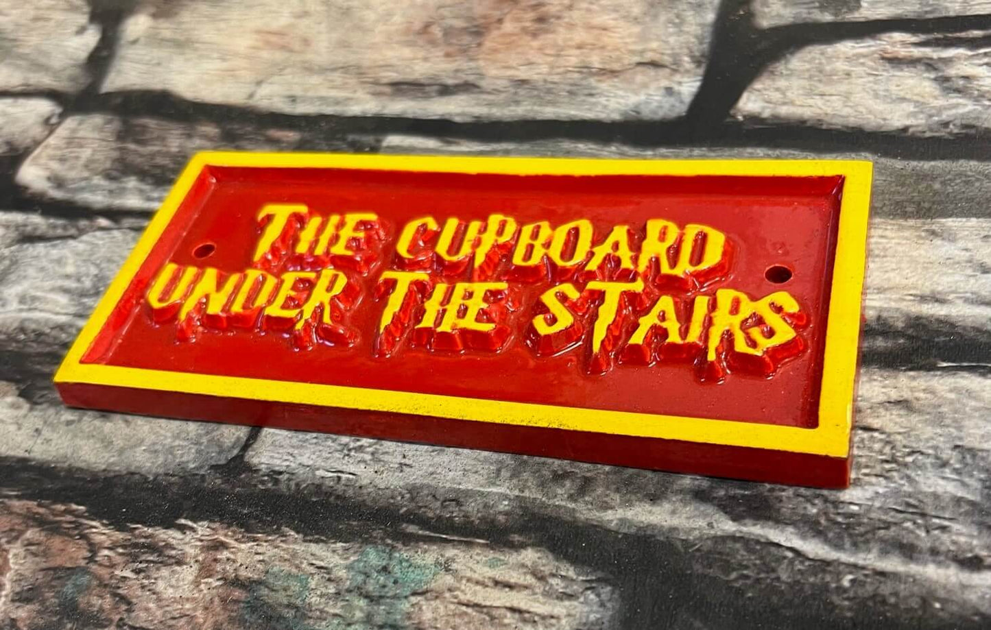 the cupboard under the stairs sign