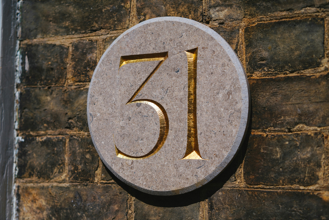 House number 31 engraved in stone plaque
