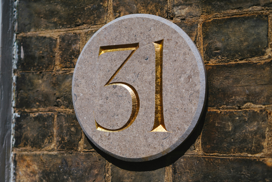 House number 31 engraved in stone plaque