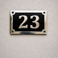 Cast aluminium rectangle house number sign with polished raised numbers and decorative border