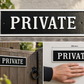 A rectangular black and white 'PRIVATE' gate sign shown in multiple views: a clean top-down product shot, mounted on a wooden gate outdoors, and a hand pressing it against a wall to show scale. The sign has a textured black background with white lettering and a white border.