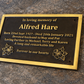 Cast bronze rectangle memorial plaque with satin finish, raised lettering and floral detail