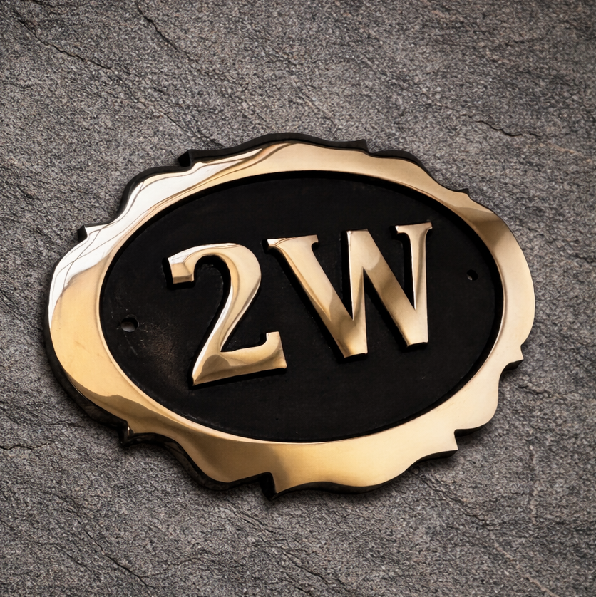 Cast bronze oval house number sign with decorative edge and raised lettering 