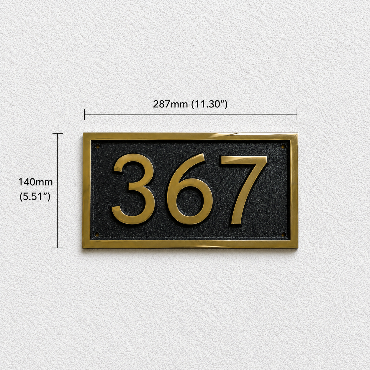 A rectangular house number plaque with the numbers 367 in gold on a black background, shown on a light textured wall with dimension lines indicating 140mm height and 287mm width.