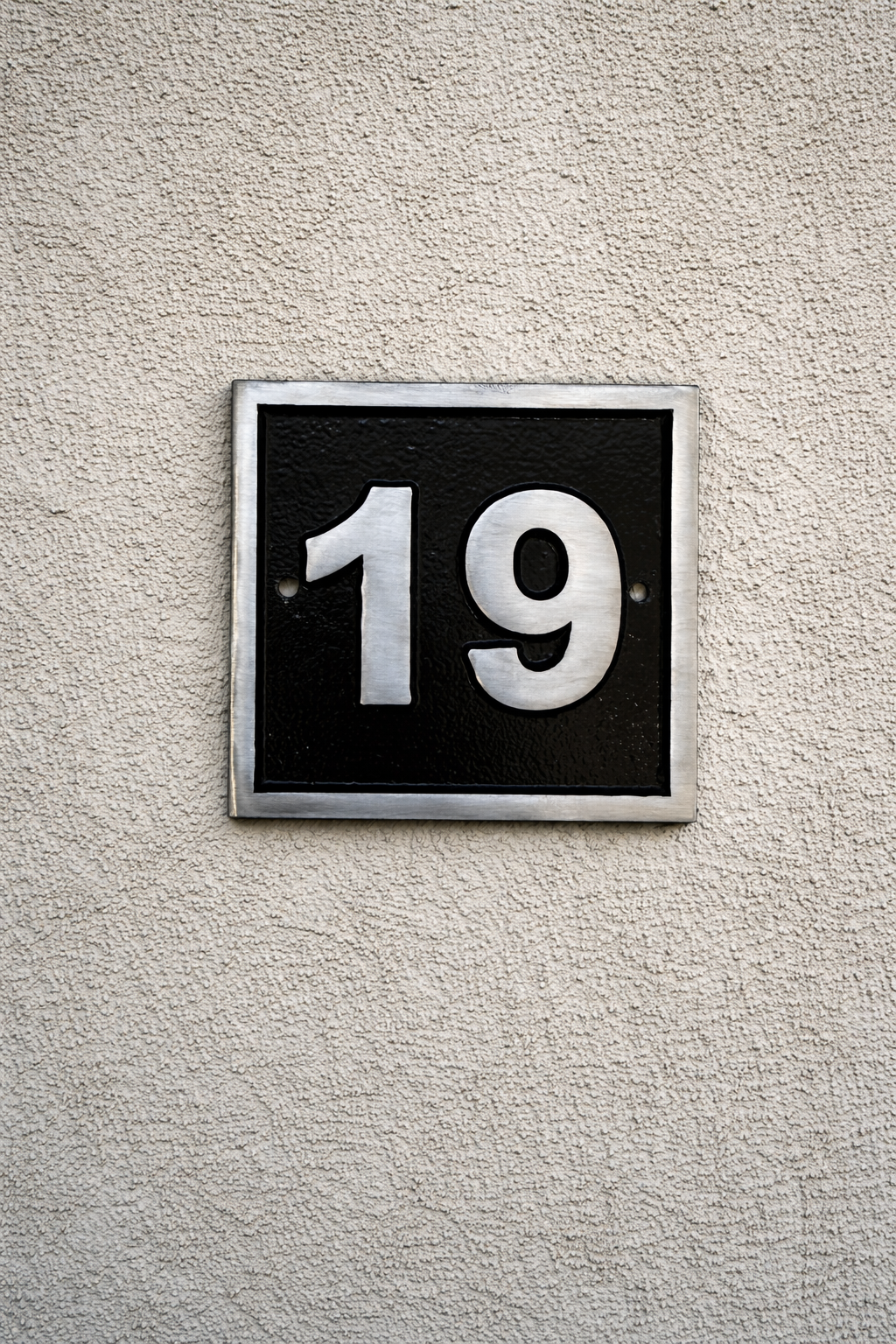 Cast aluminium square house number sign with raised satin numerals black background and background fixing holes