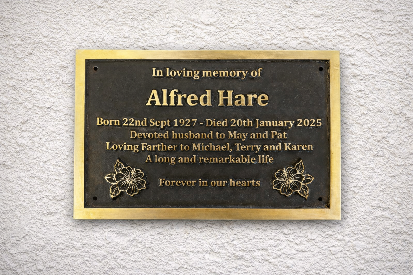 Cast bronze rectangle memorial plaque with satin finish, raised lettering and floral detail