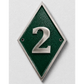 A diamond-shaped green house number plaque with a silver metallic border and the number '2' in raised silver lettering, mounted on a light gray textured wall.