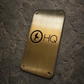 Custom brass business sign with engraved company logo mounted on wall