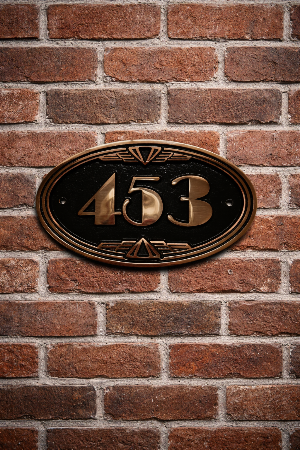 Close up of cast bronze number sign showing textured background and polished numerals