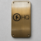 Custom brass business sign with engraved company logo mounted on wall
