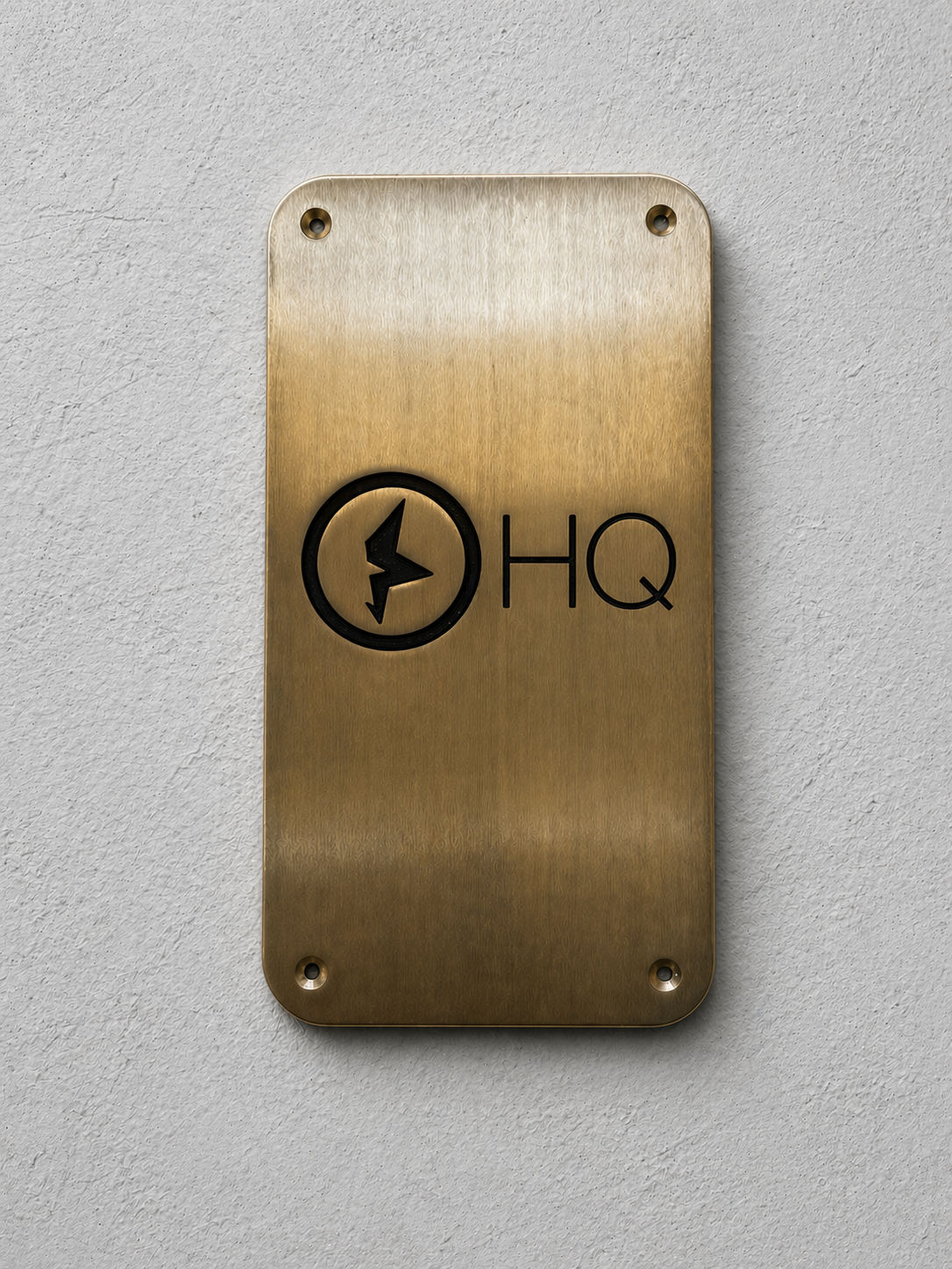 Custom brass business sign with engraved company logo mounted on wall