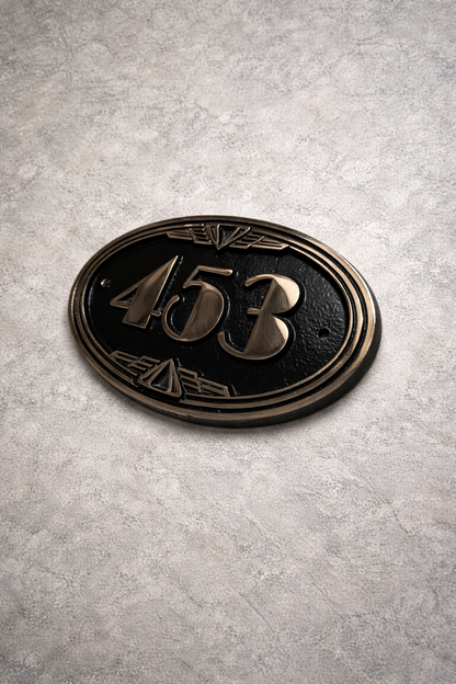 Hand finished cast bronze number sign showing depth and surface texture