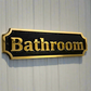 bathroom sign in bronze