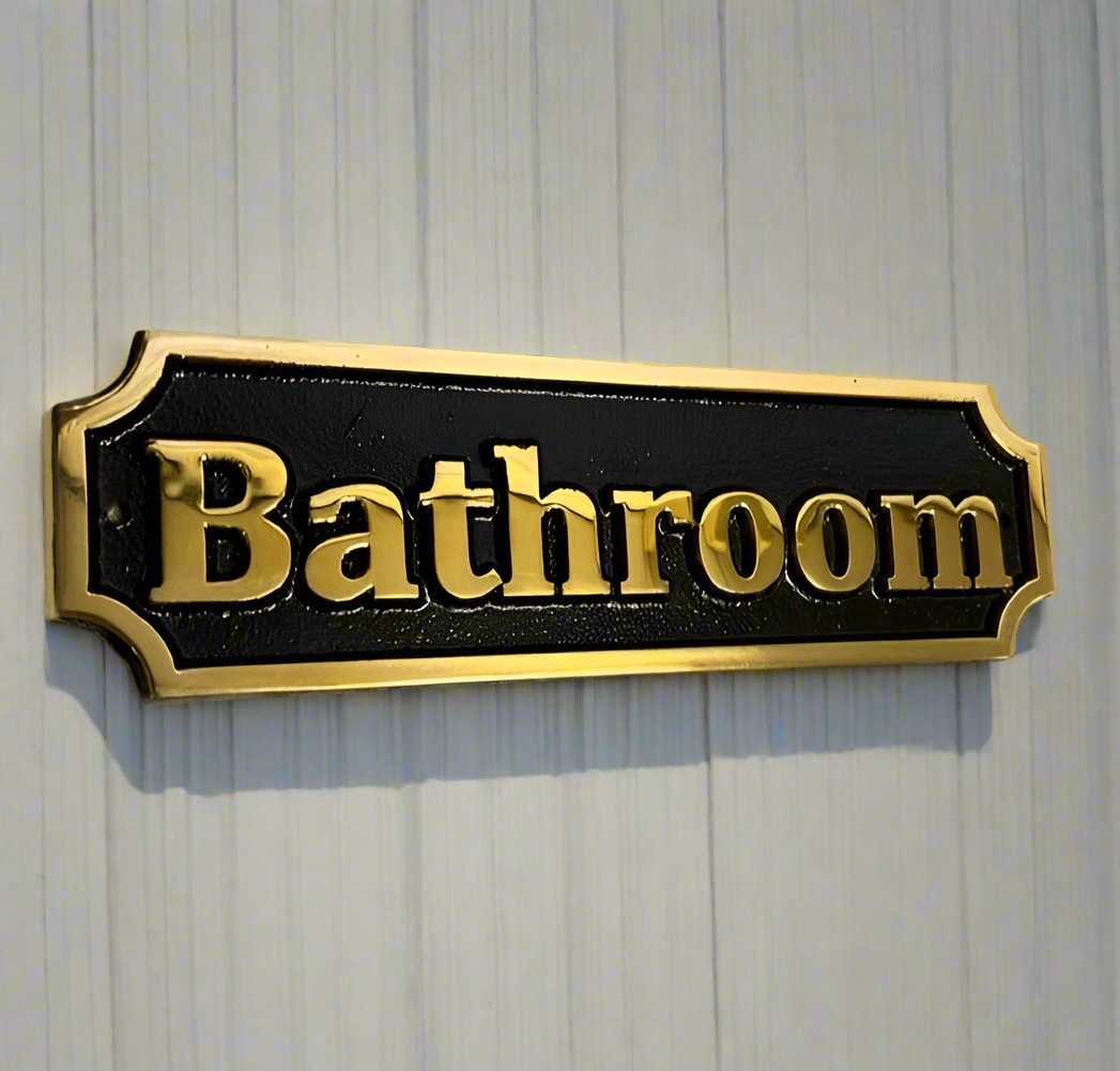 bathroom sign in bronze