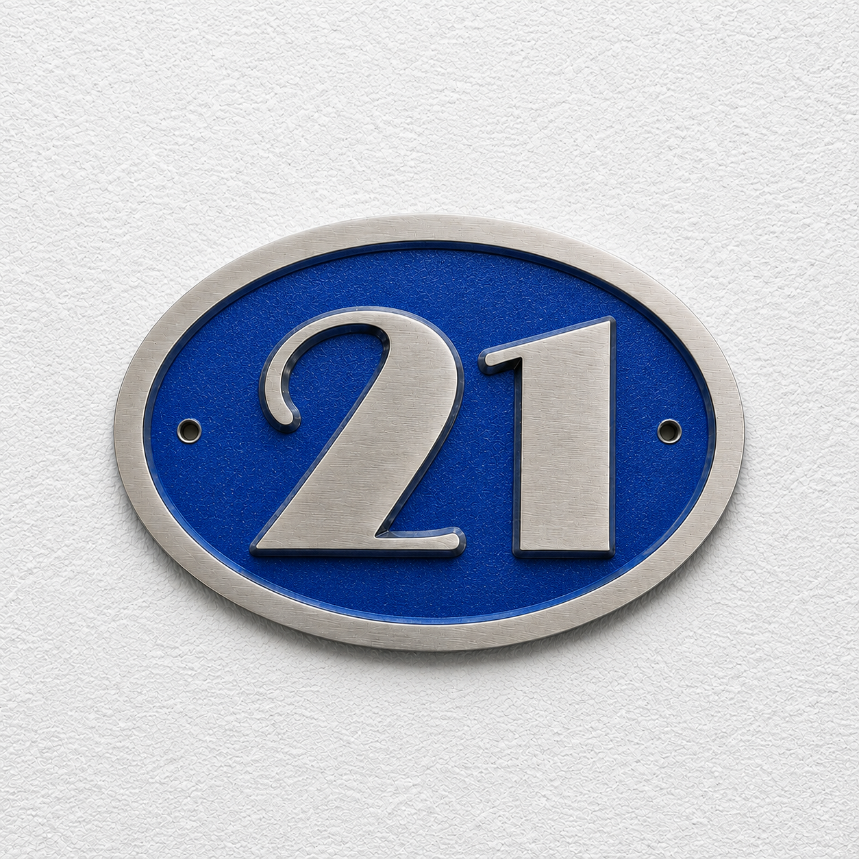 An oval house number plaque featuring the number 21 in brushed silver metal over a vibrant blue background, mounted on a textured white wall.