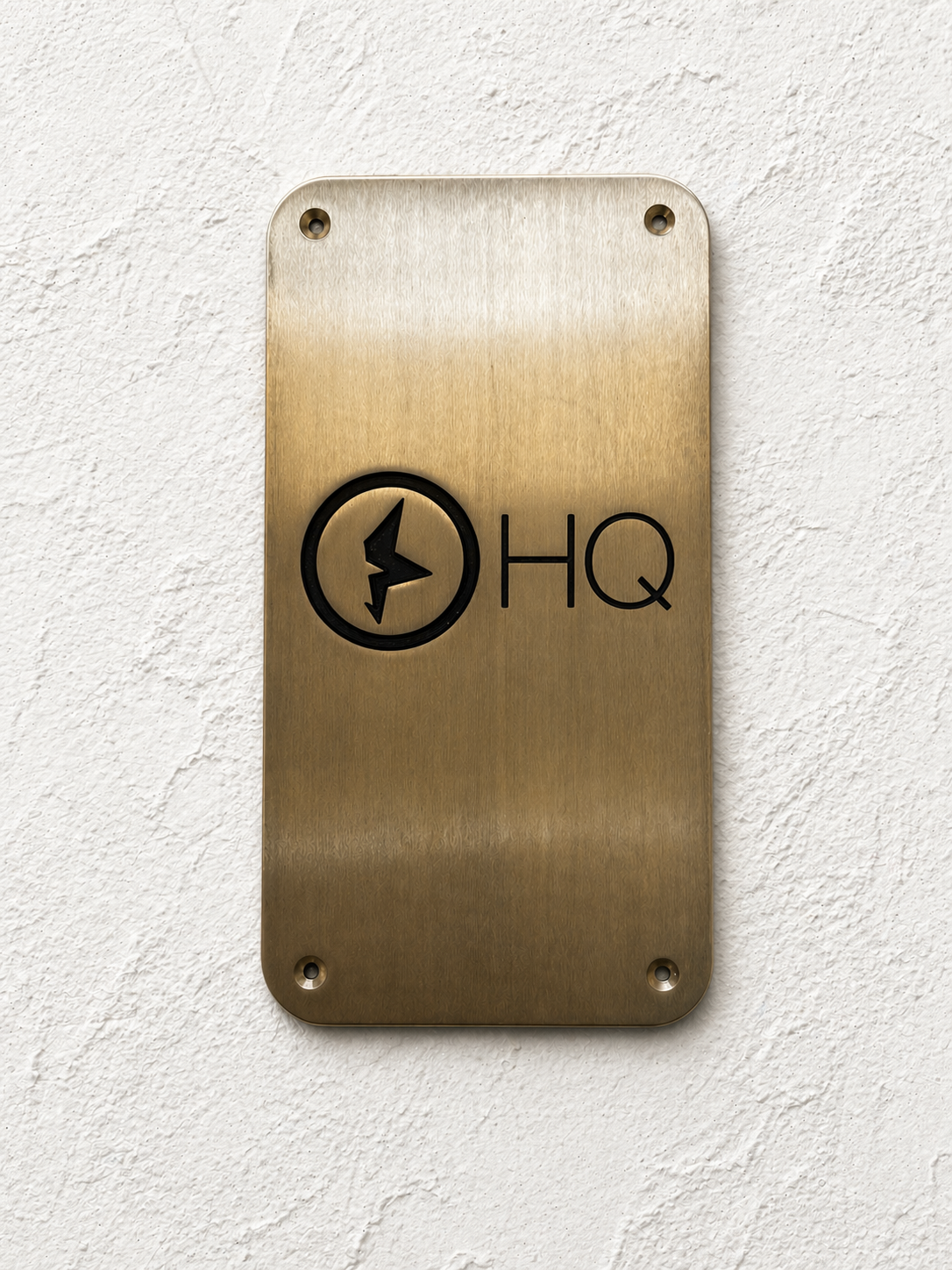 Custom brass business sign with engraved company logo mounted on wall