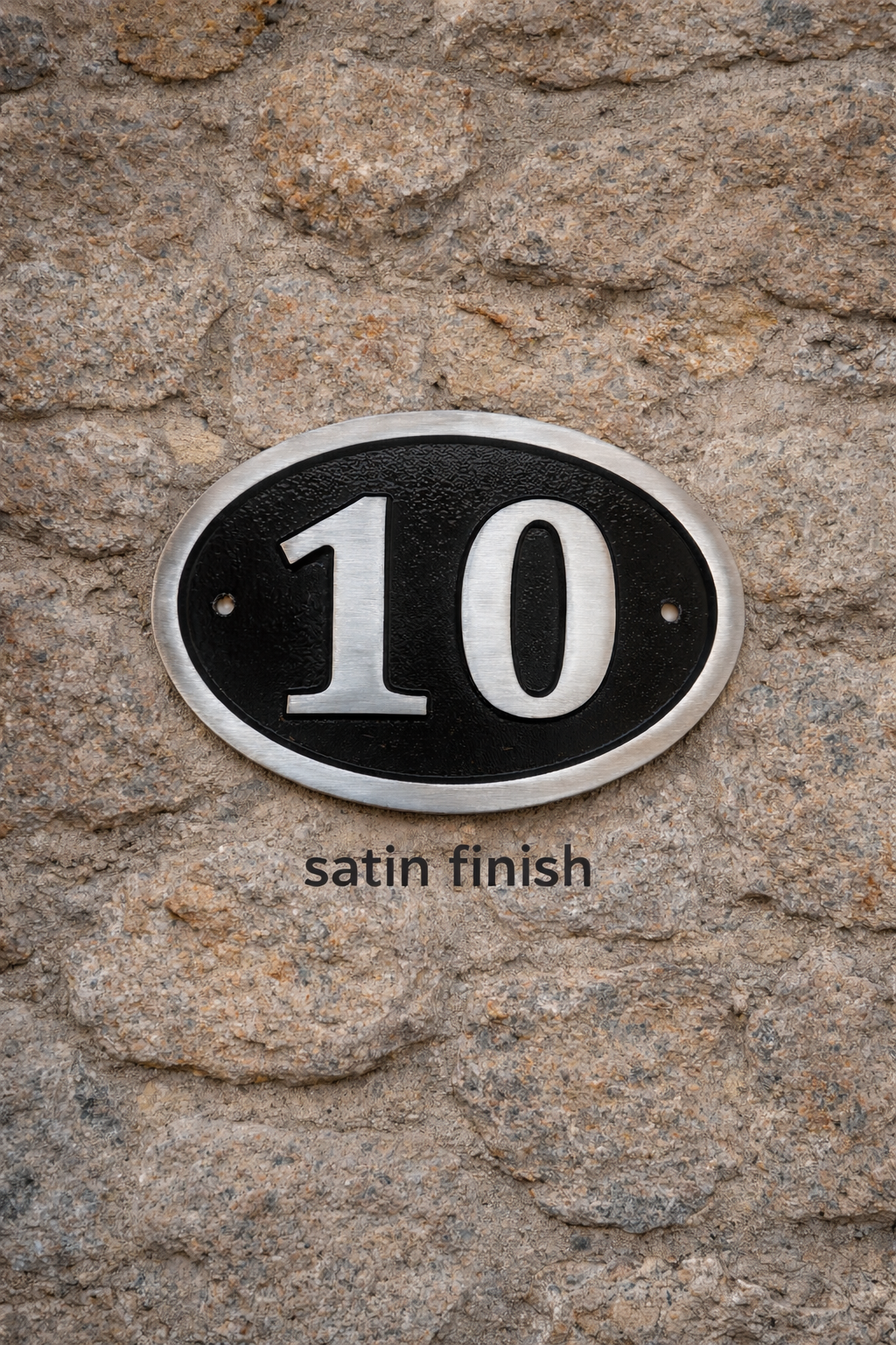Cast aluminium oval hotel room number sign with raised numbers and black background mounted on wall