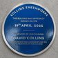 Modern blue heritage plaque with brushed silver border and raised lettering mounted on exterior wall