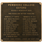 A rectangular bronze commemorative plaque with raised gold lettering for Pembroke College Oxford Double Headship 2025, listing player and coach names in two columns, photographed against a plain white background.