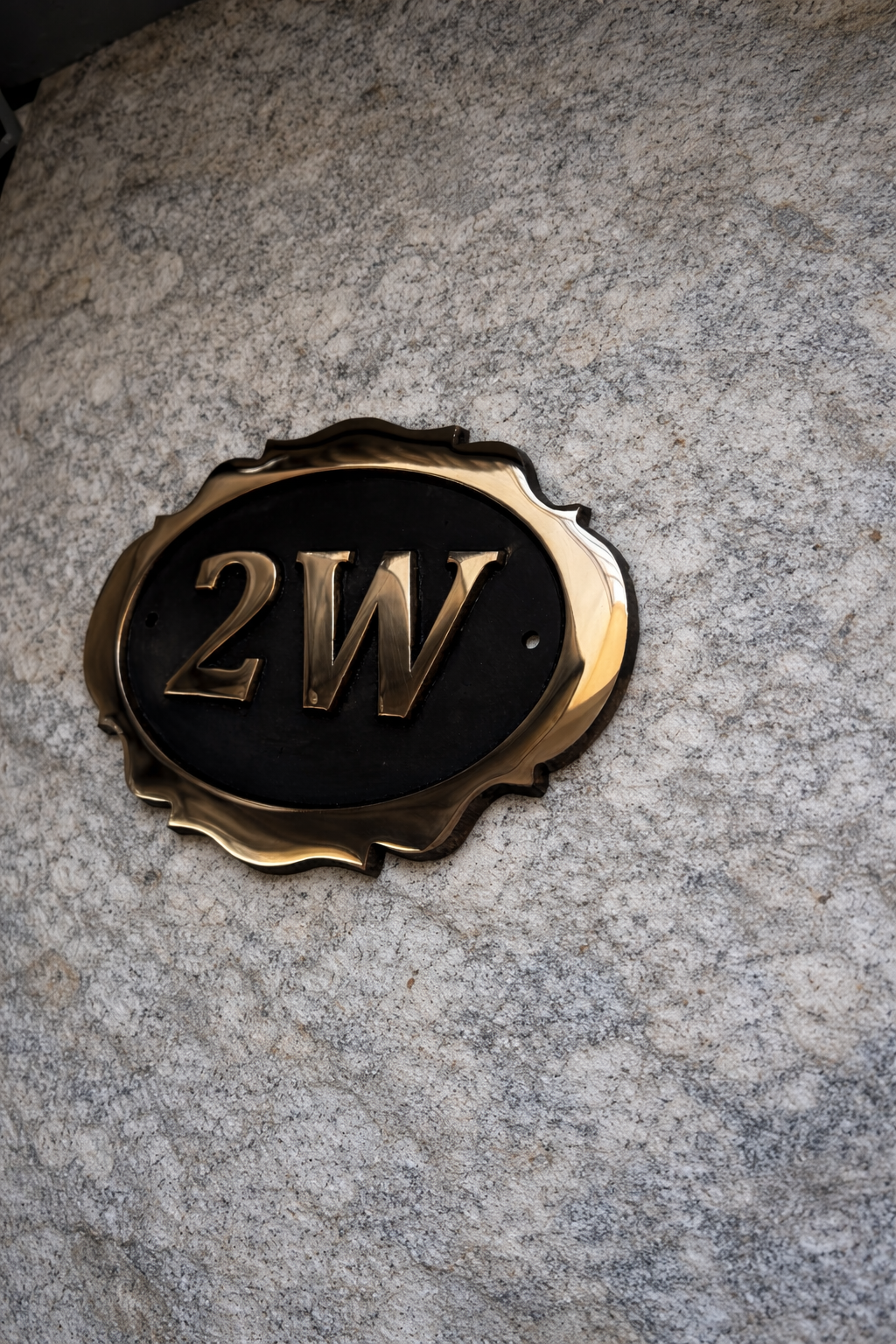 Cast bronze oval house number sign with decorative edge and raised lettering 