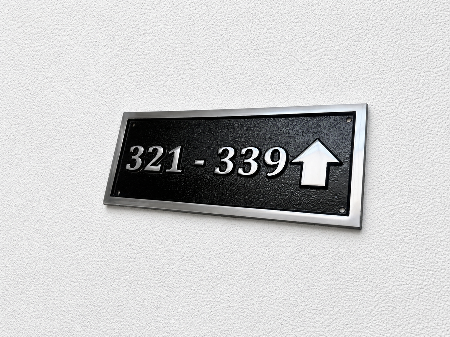 Cast aluminium directional sign with custom text and arrow for hotel or office wayfinding