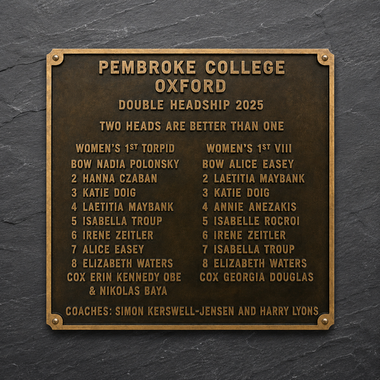 A bronze double headship plaque for Pembroke College Oxford, featuring gold-colored text listing student leaders and coaches for the year 2025, mounted on a dark slate background.