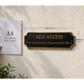 A black ADA Access plaque with gold lettering mounted on a textured beige wall, shown next to an A4 paper size reference held by a hand. The image includes dimension lines indicating the plaque is 300mm by 100mm.