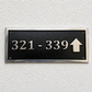Cast aluminium directional sign with custom text and arrow for hotel or office wayfinding