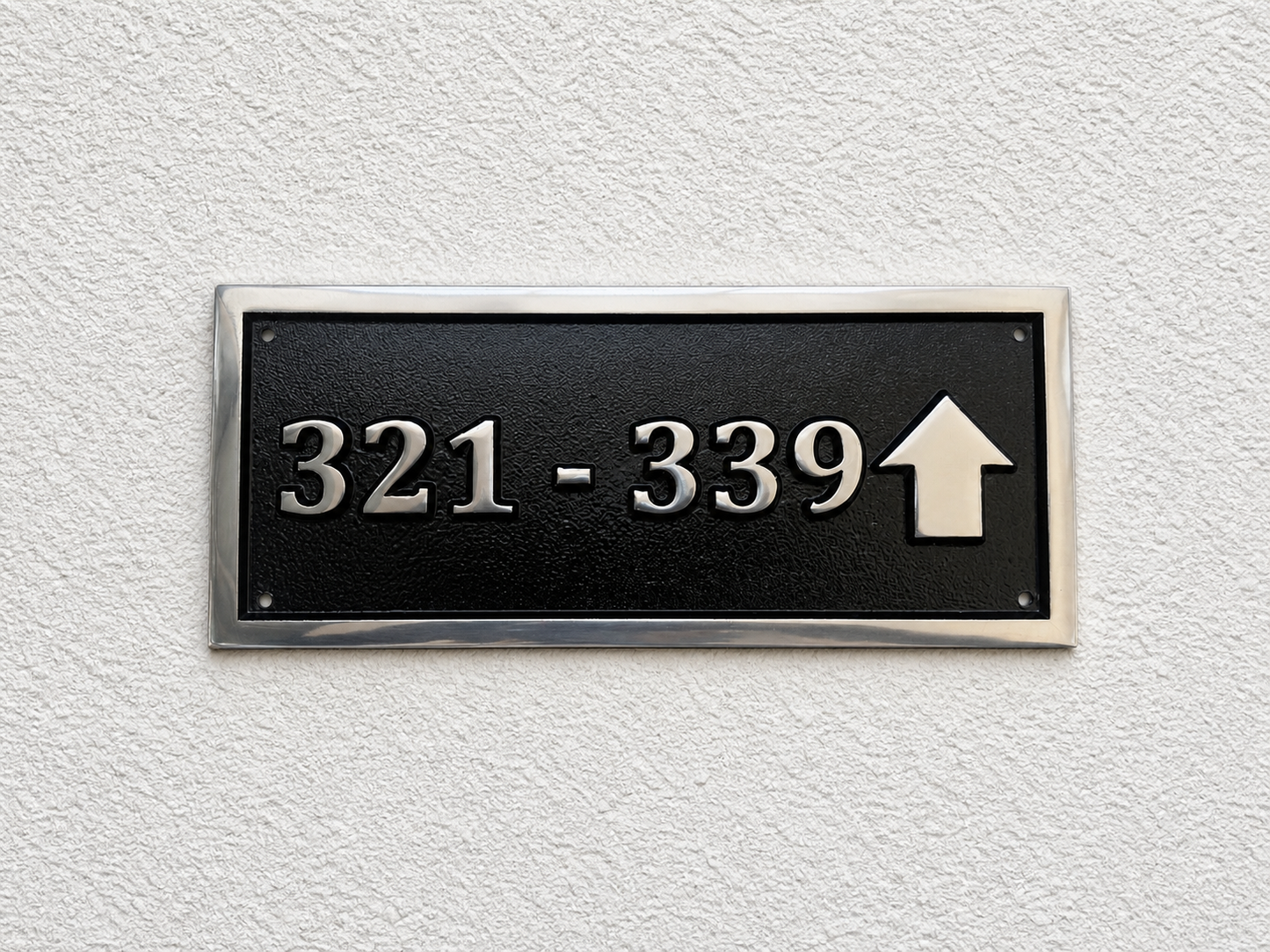 Cast aluminium directional sign with custom text and arrow for hotel or office wayfinding