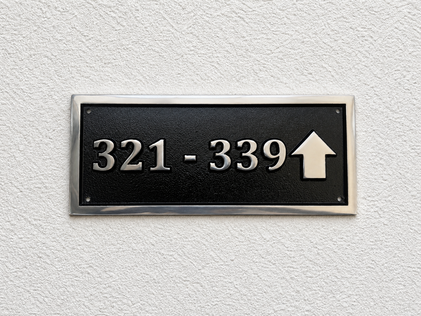 Cast aluminium directional sign with custom text and arrow for hotel or office wayfinding