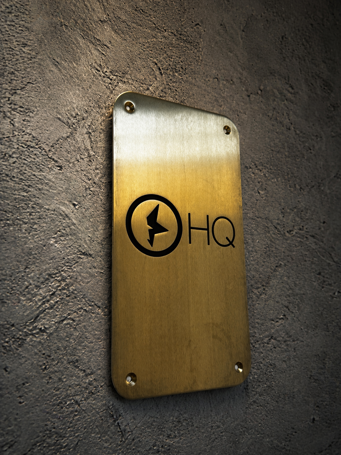 Custom brass business sign with engraved company logo mounted on wall