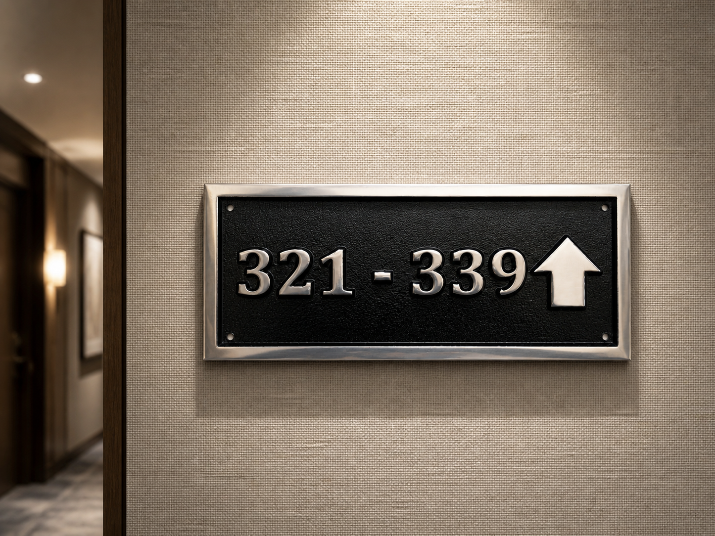 Cast aluminium directional sign with custom text and arrow for hotel or office wayfinding