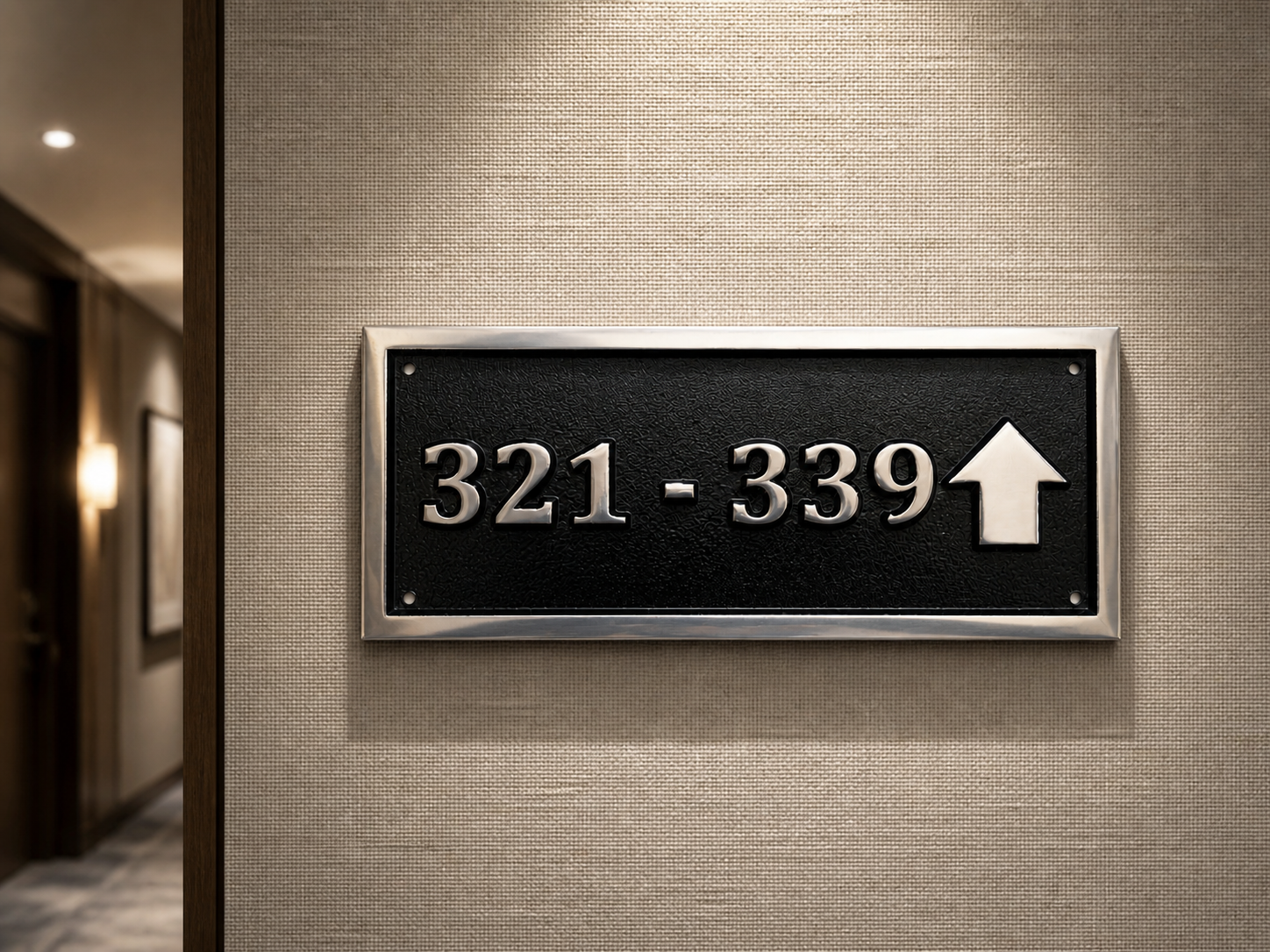 Cast aluminium directional sign with custom text and arrow for hotel or office wayfinding