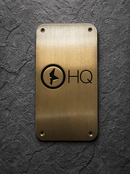 Custom brass business sign with engraved company logo mounted on wall