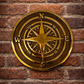  Cast bronze compass wall plaque with raised compass rose detail mounted on exterior wall