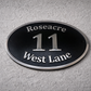 Cast aluminium oval house sign with custom name and number - black