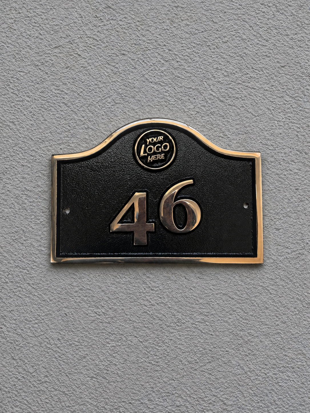 Cast bronze hotel room number sign with custom logo and raised numbers mounted on wall